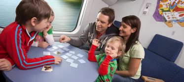 Kids playing games on train family holiday