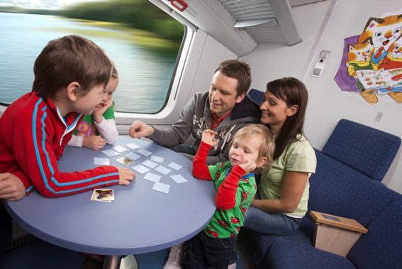 Kids playing games on train family holiday
