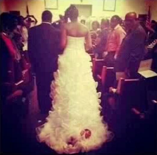 bride drags baby down the aisle attached to dress