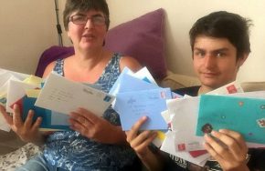 autistic boy and mum with cards